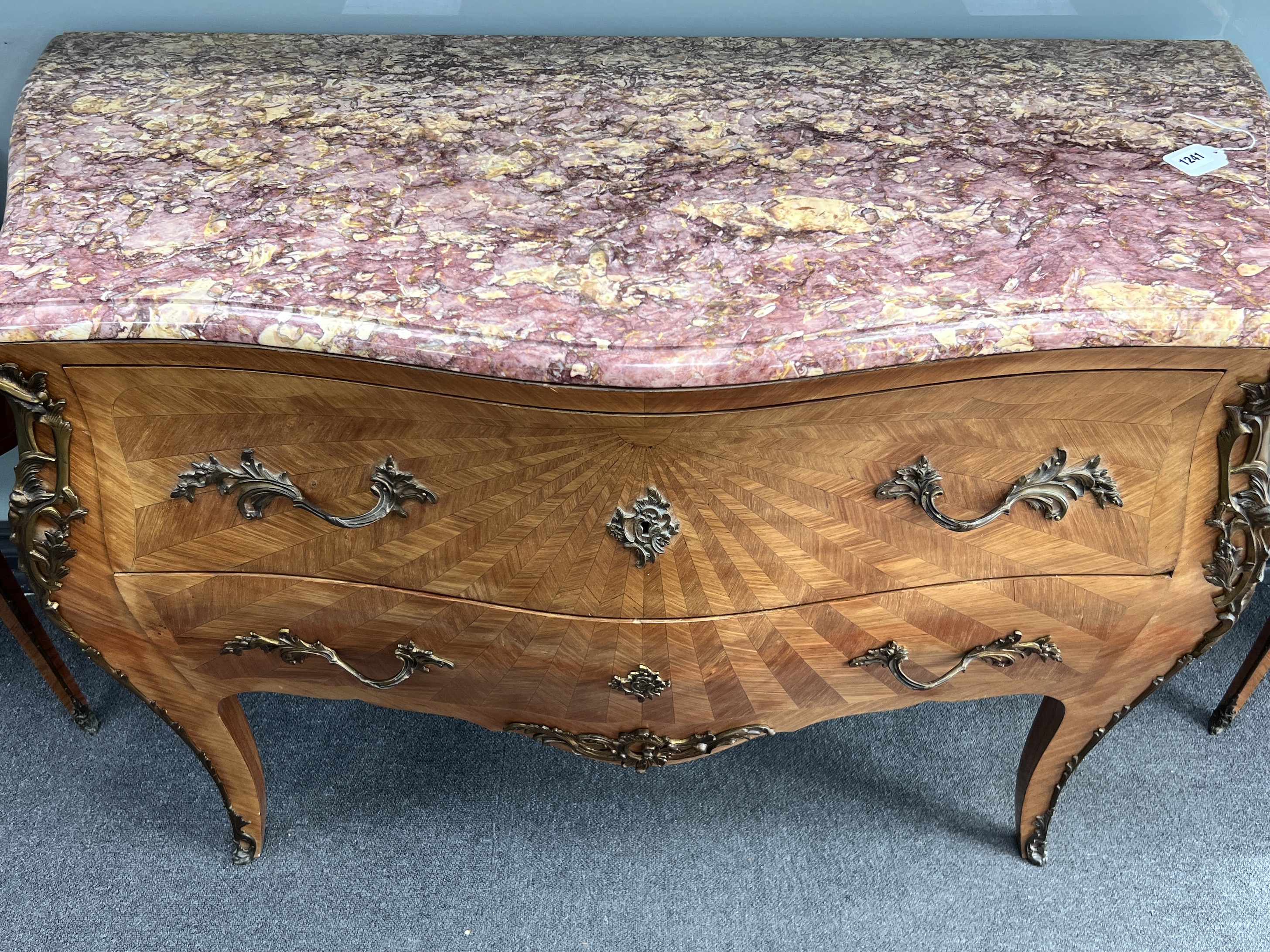 A French Louis XVI style parquetry bombe fronted rouge marble topped commode, width 120cm, height 85cm